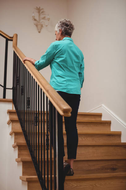 istock Senior woman walking up stairs 656203344