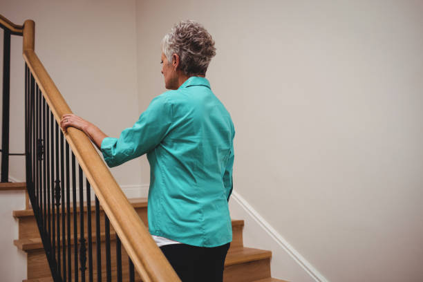 istock Senior woman walking up stairs 656203406