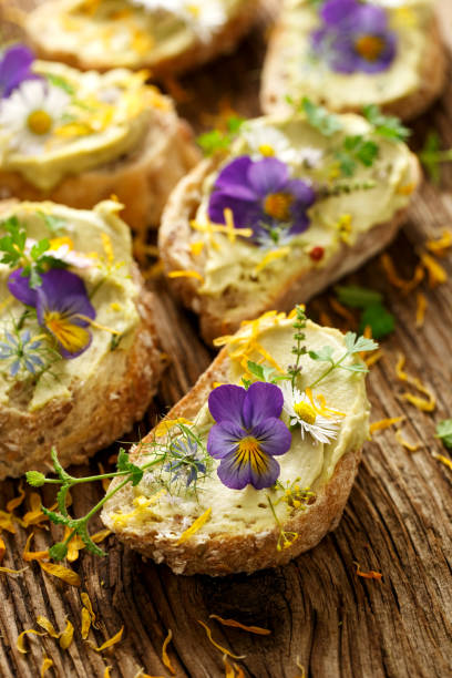 istock Canapes with eddible flowers and broad bean hummus 656204092