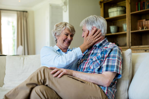 istock Senior couple sitting together on sofa 656204316