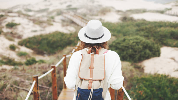 istock woman traveling among sand meadows 656204482