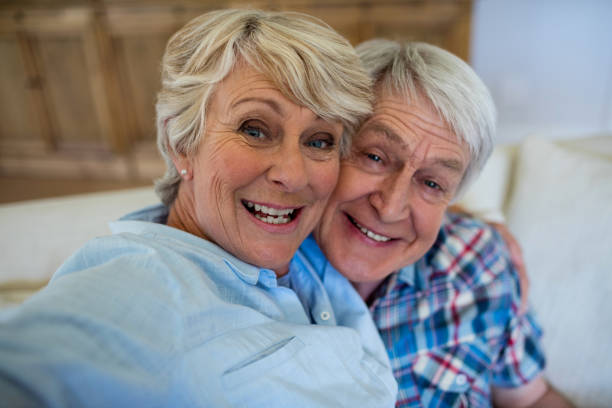 istock Senior couple relaxing on sofa in living room 656204486