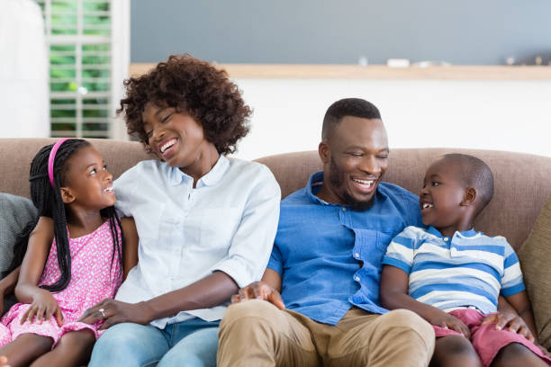 istock Parents and kids interacting while sitting on sofa in living room 656207354