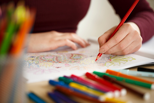 Close Up Woman Hands Coloring An Adult Coloring Book