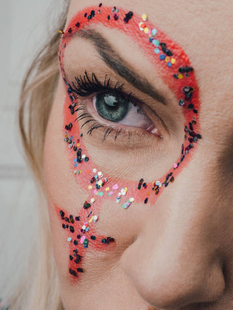 Fashion beauty glamor girl. Face in glistening powder. Close-up portrait of a woman on a black background