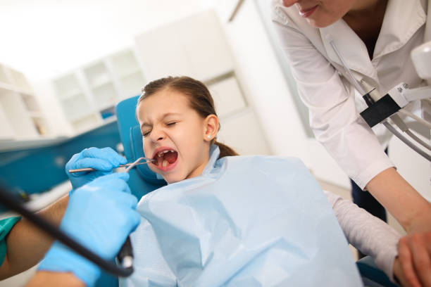 istock Portrait of a scared young patient having dental examination. 656231008
