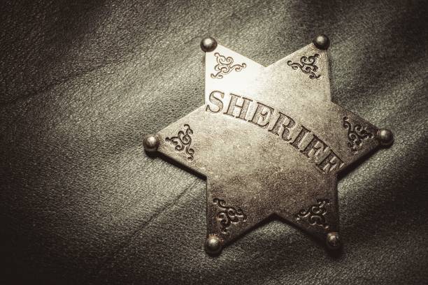 istock Sheriff badge on gray leather texture background. 656234474