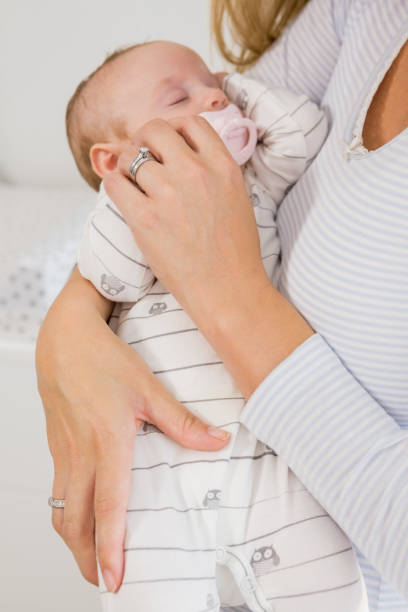 istock Mid-section of mother holding her baby boy 656234898