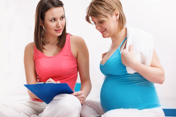 istock Pregnant Woman Practicing Yoga With Her Teacher 656241446