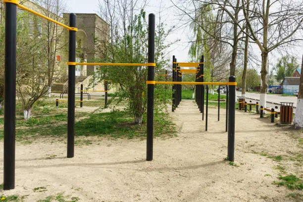 Playground with a horizontal bar on a city street. Spring
