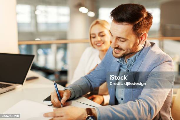 Young Business Couple Signing A Contract Stock Photo - Download Image Now - Financial Loan, Bank - Financial Building, Signing