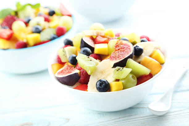 istock Fresh fruit salad on a white wooden table 656245664