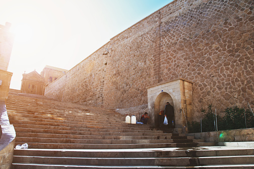 Father and son fill plastic containers with water at a public fountain in the city of Mardin, Turkey on May 11, 2012. 