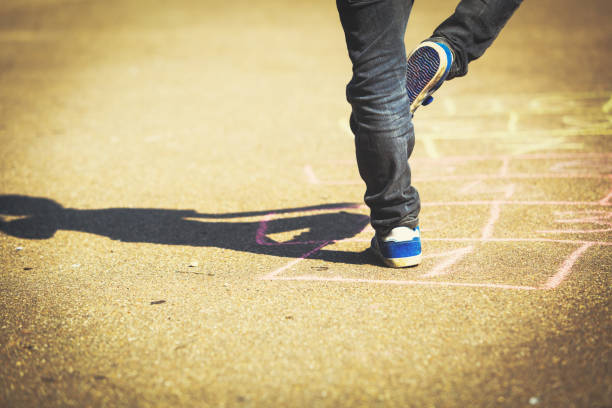 istock little boy playing hopscotch on playground 656263264