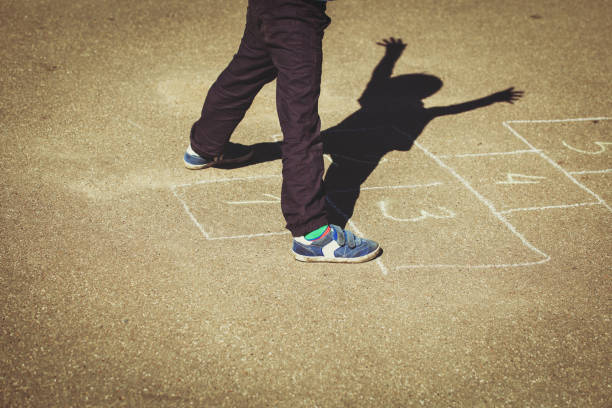 istock little boy playing hopscotch on playground 656263658