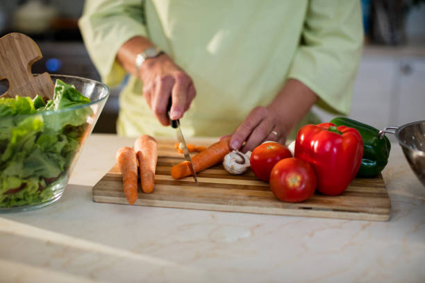 istock Senior woman cutting vegetables for salad 656268088