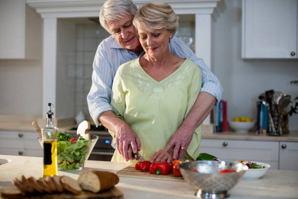 istock Senior couple cutting vegetables in kitchen 656268164