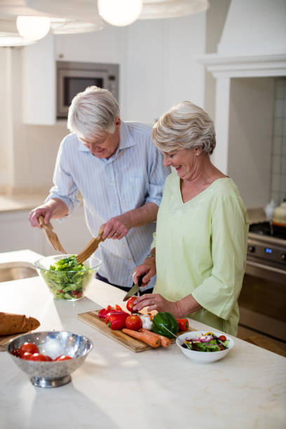 istock Happy senior couple preparing vegetable salad 656268190