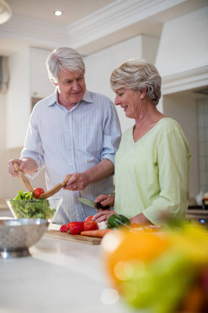 istock Happy senior couple preparing vegetable salad 656268226