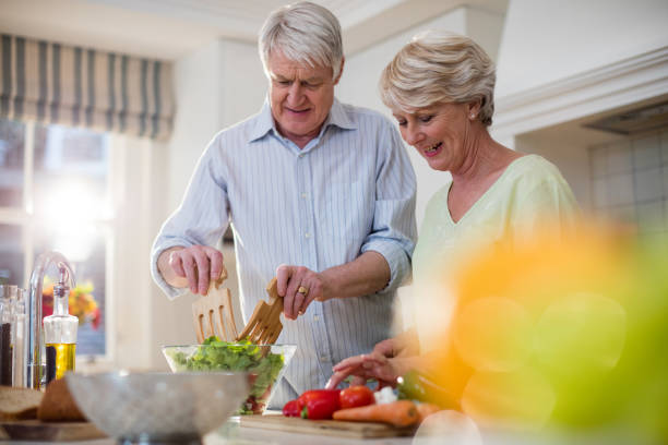 istock Happy senior couple preparing vegetable salad 656268262