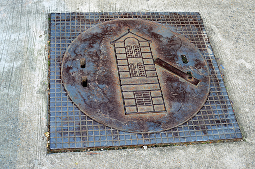 Square manhole with architecture pattern.