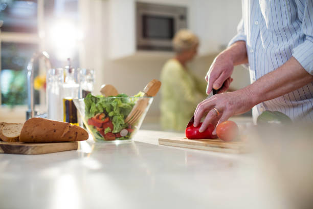istock Senior man cutting vegetables for salad 656268426