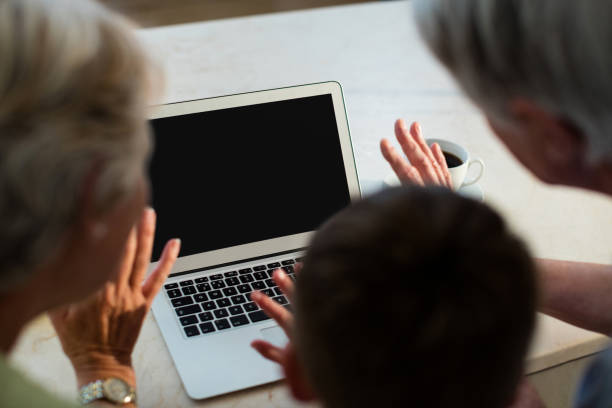 istock Grandson using laptop with grandparents 656271754