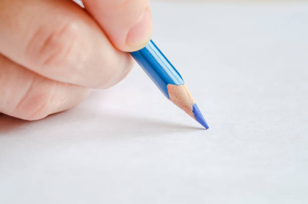 istock Woman's hand holding a pencil on white 656271884