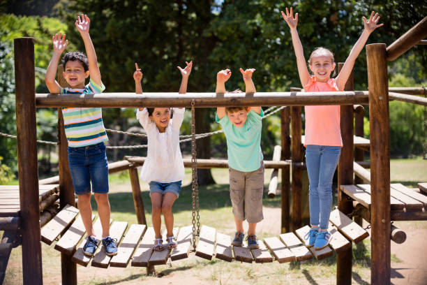 istock Kids standing and smiling on a playground ride in park 656272366