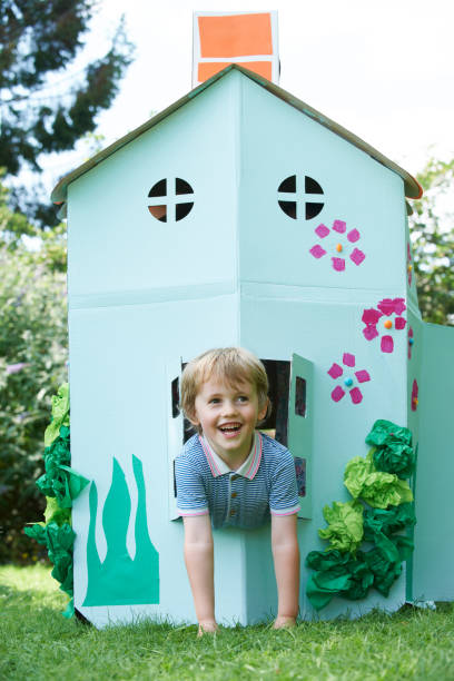 istock Young Boy Playing In Home Made Cardboard House 656277524