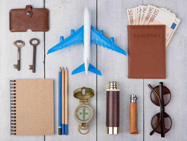 istock plane, passport, money, compass, sunglasses, binoculars, note pad, keys, wallet 656279692