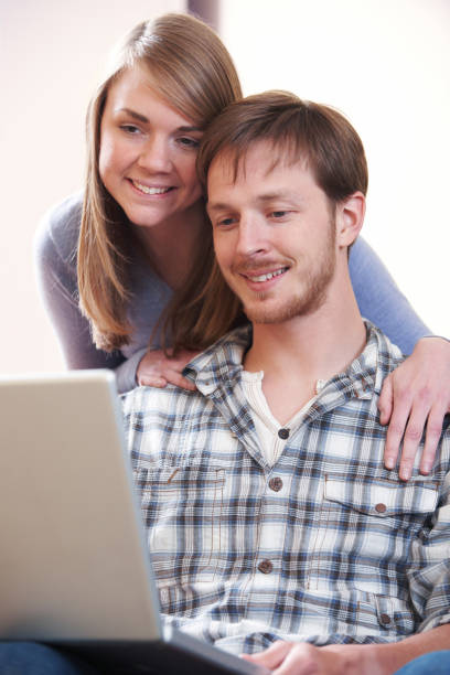 istock Young Couple Looking At Laptop Together 656282464