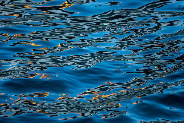 istock colorfull light reflections at the blue water 656285646
