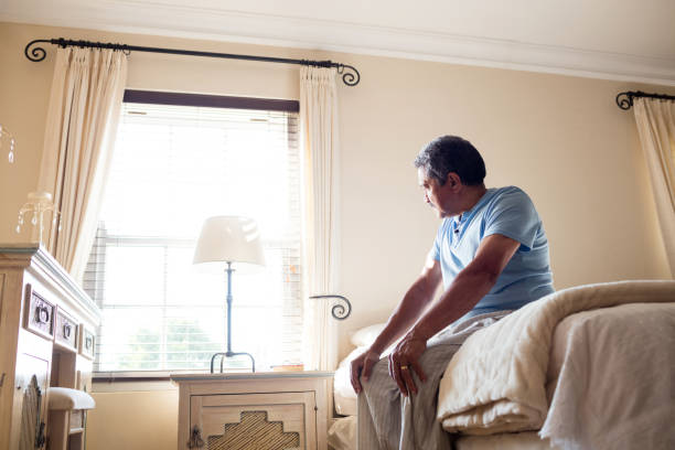 istock Thoughtful senior man looking through window in bedroom 656286282