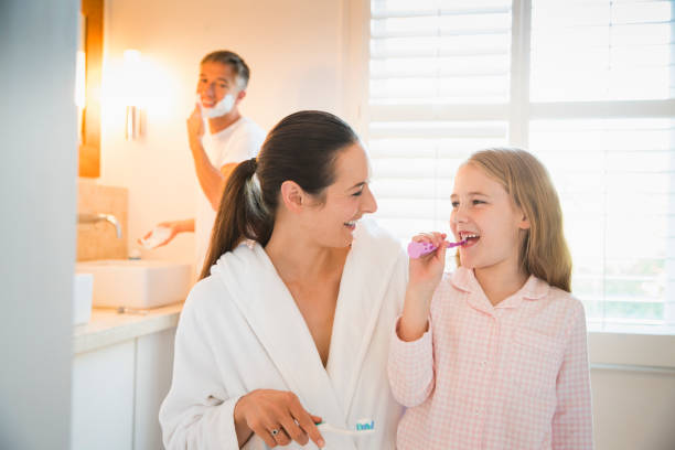 istock Mother and daughter brushing teeth in bathroom 656287201