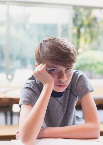 istock Portrait of bored boy doing homework 656287239