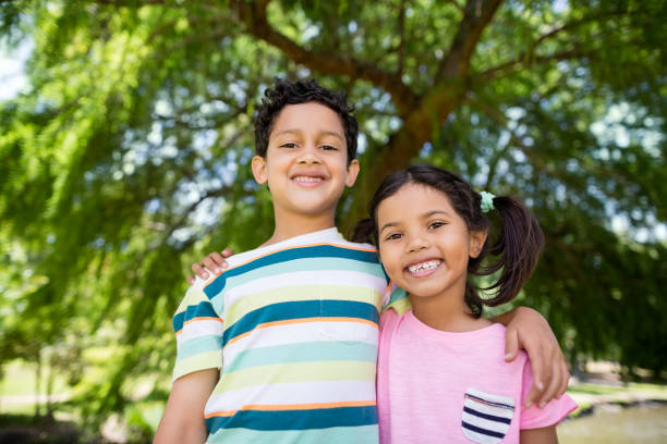 istock Portrait of two siblings standing together in park 656287302