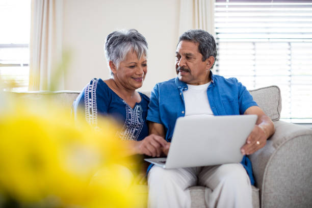 istock Senior couple using laptop in living room 656287482