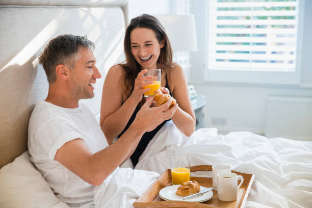 istock Smiling couple enjoying breakfast in bed 656287775