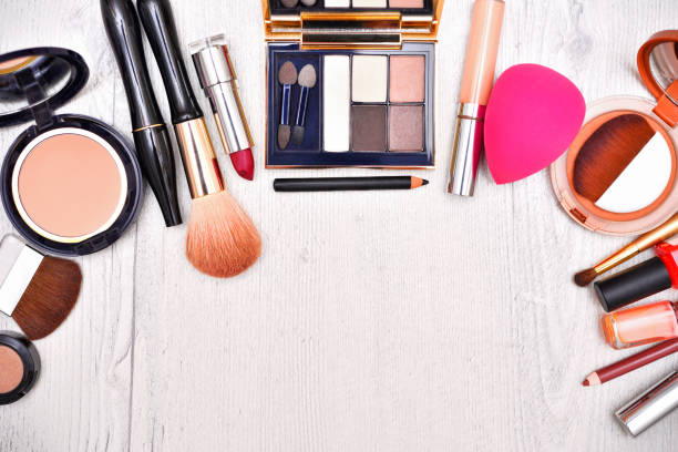Various make up products on wooden background. Top view.