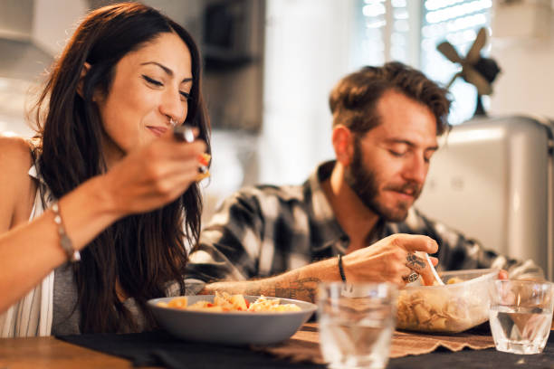 istock Young couple eating together at home 656297770