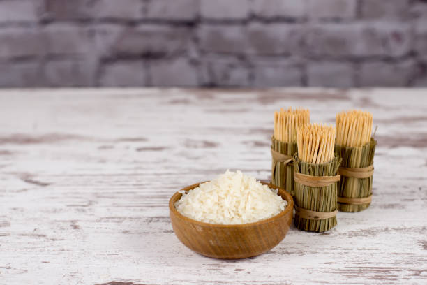 rice and toothpicks. vintage boards. selective focus. - brown rice fotos imagens e fotografias de stock