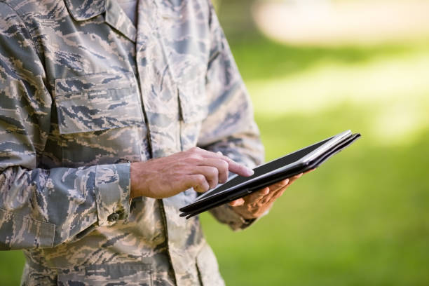 istock Mid-section of soldier using digital tablet in park 656304462