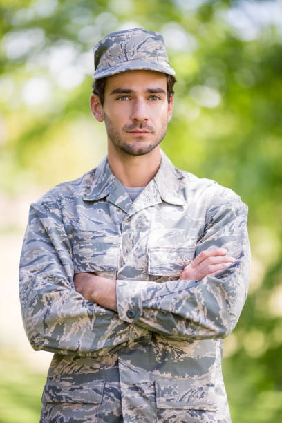 istock Soldier standing with arms crossed in park 656304562