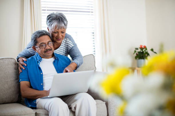 istock Senior couple using laptop in living room 656304628