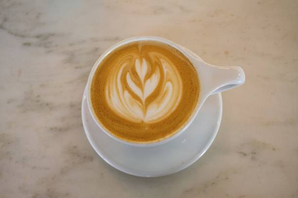 istock Flower Latte Coffee White Cup Marble Wood Table 656305244