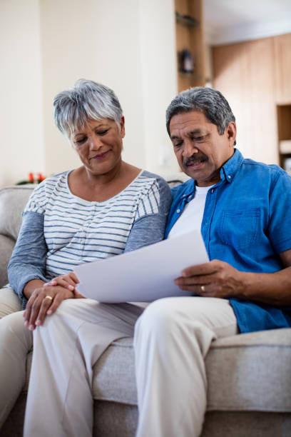 istock Senior couple checking bills in living room 656305906