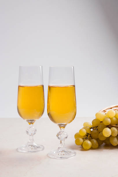 istock White wine and grapes. White wine in glasses and grapes 656314994