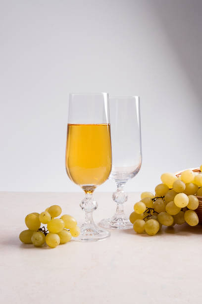 istock White wine and grapes. White wine in glass and grapes 656315044