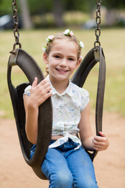 istock Happy girl sitting on a swing in park 656315532